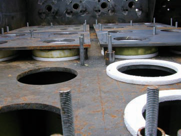Installation step 1 — placing the gasket and lowering the ceramic filter element into the tubesheet