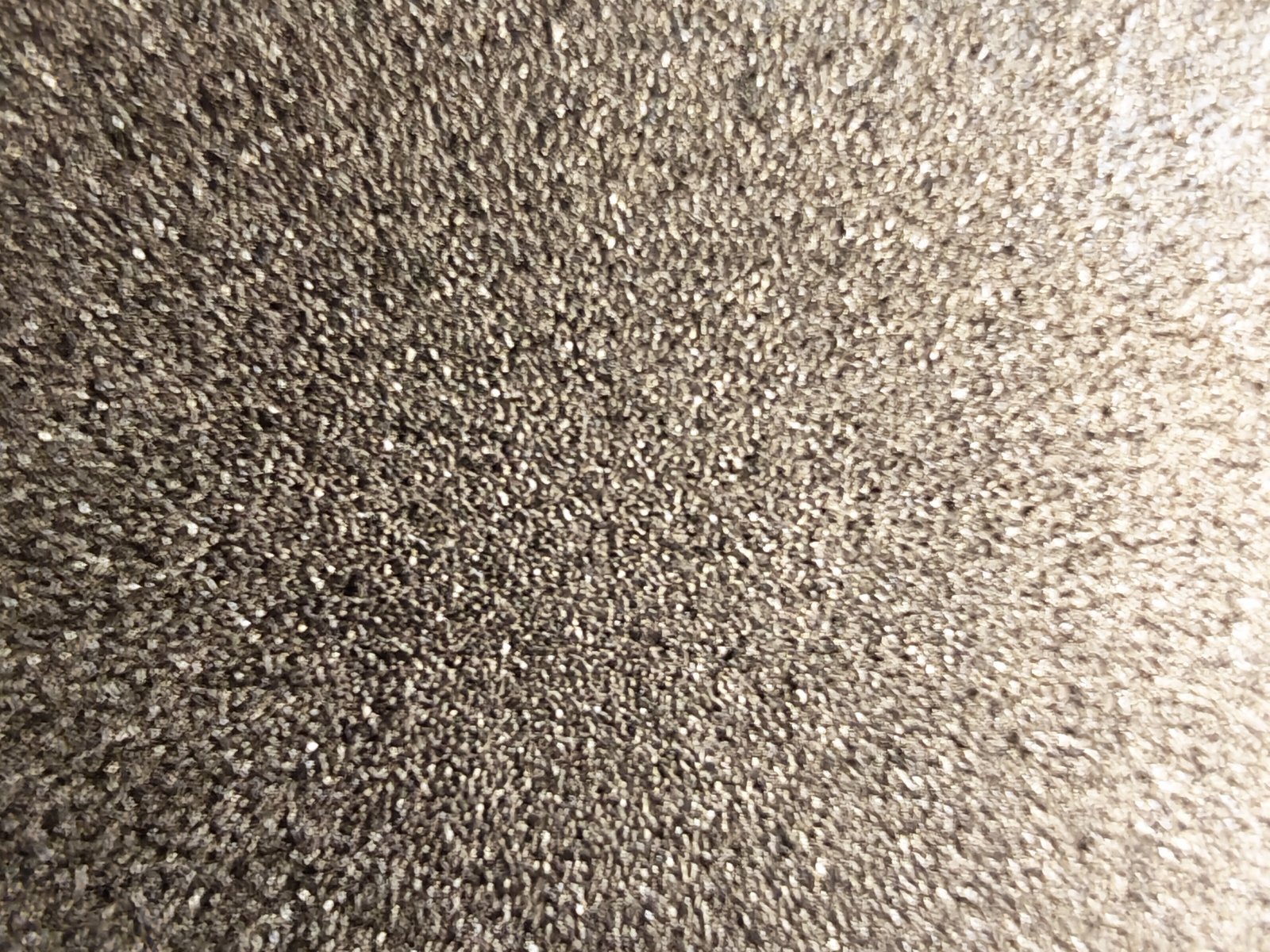 Porous titanium plate surface texture close-up